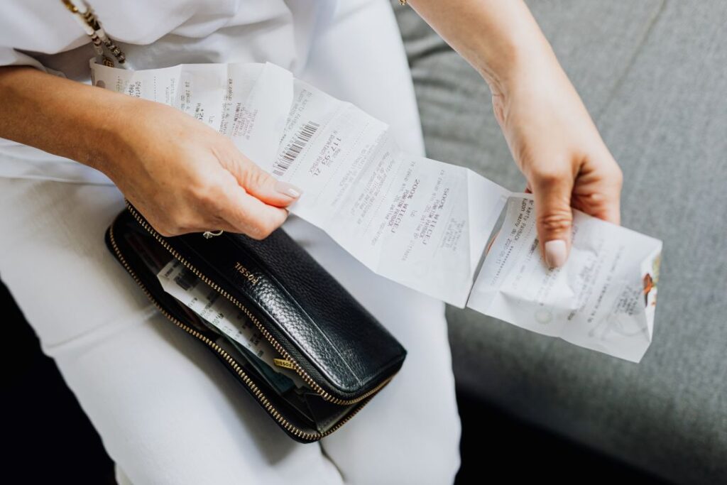 A woman looking at her expense reciepts. 
